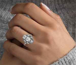Hand with vintage three diamonds ring